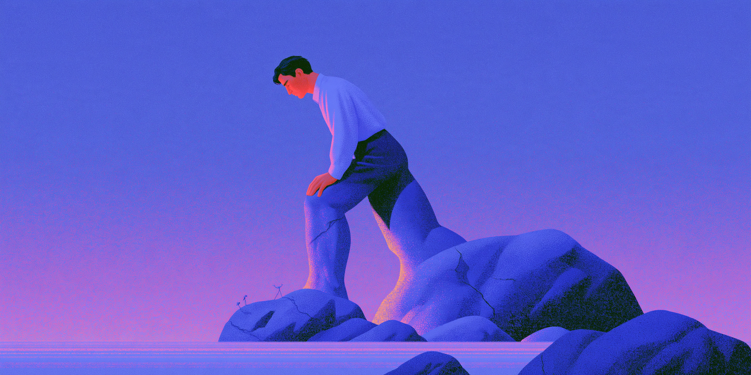 A man in a light shirt stands on smooth blue rocks at dusk, bending forward and holding his leg as if easing a cramp.